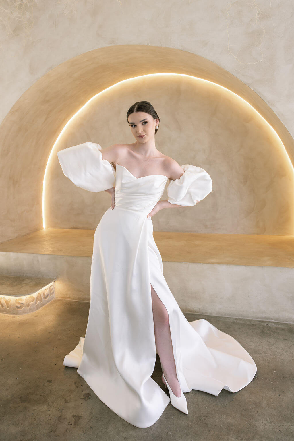 Heston wedding dress with puff sleeves, fitted bodice and satin skirt with leg split.