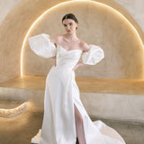 Heston wedding dress with puff sleeves, fitted bodice and satin skirt with leg split.