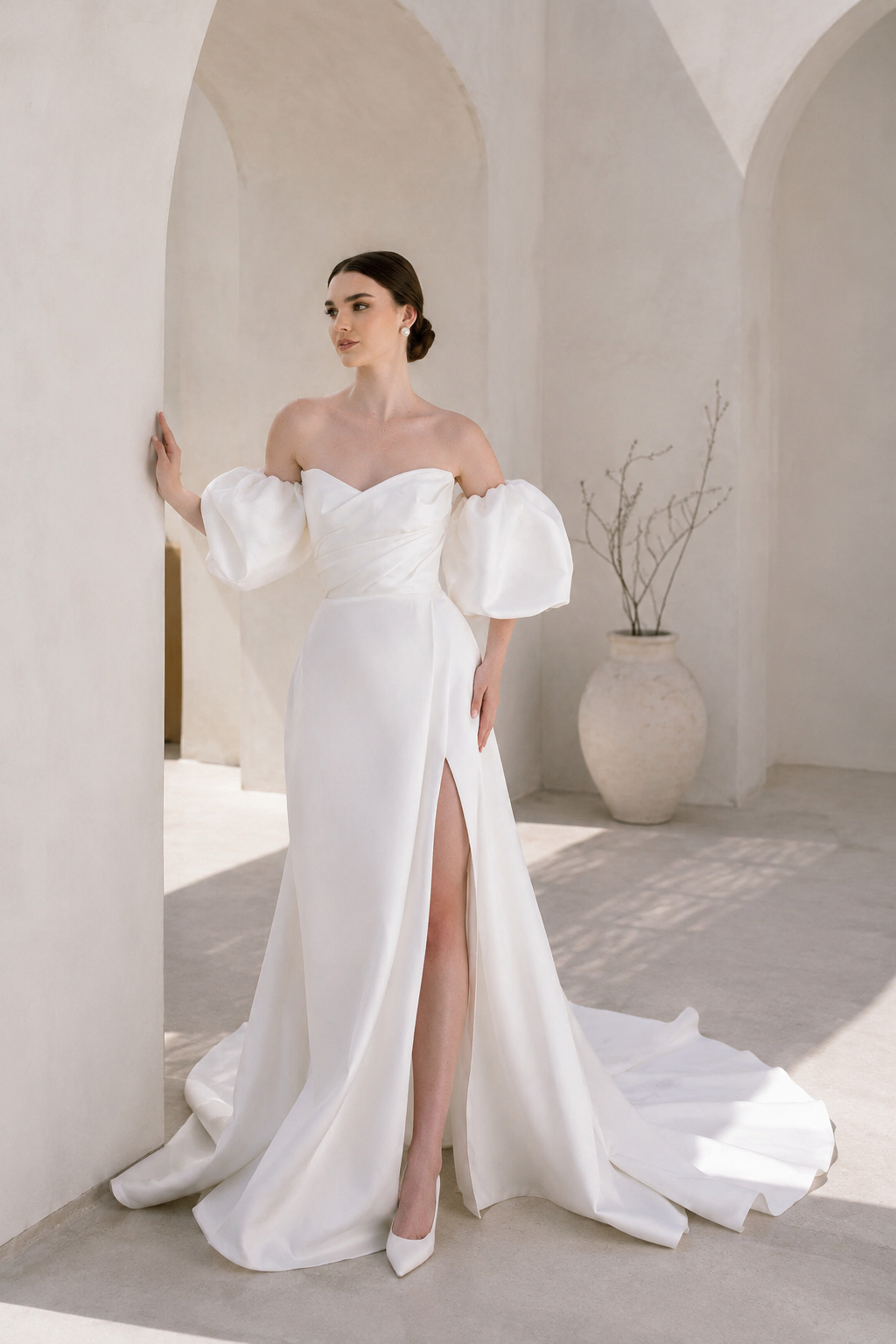 Heston wedding dress with puff sleeves, fitted bodice and satin skirt with leg split.