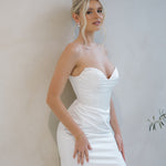 Bride wearing the Intentions crepe satin fit-and-flare wedding dress with a draped sweetheart neckline.

