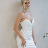 Bride wearing the Intentions crepe satin fit-and-flare wedding dress with a draped sweetheart neckline.
