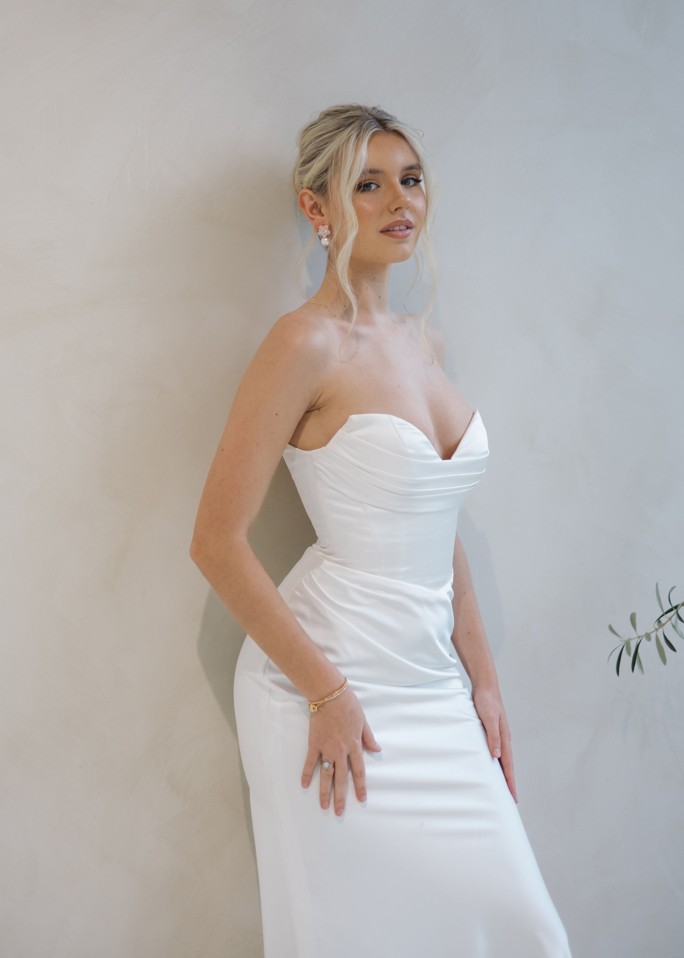 Bride wearing the Intentions crepe satin fit-and-flare wedding dress with a draped sweetheart neckline.
