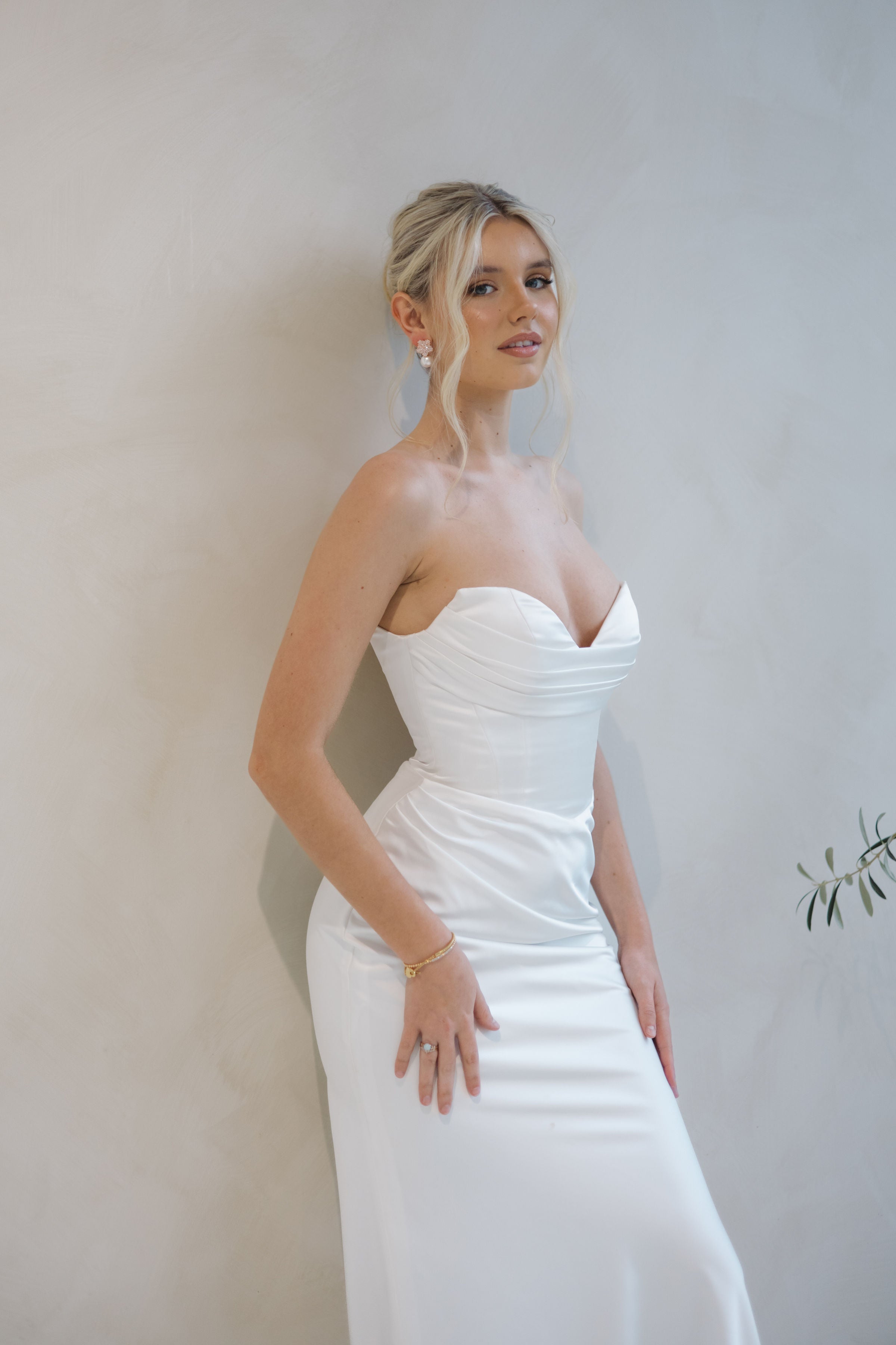 Bride wearing the Intentions crepe satin fit-and-flare wedding dress with a draped sweetheart neckline.
