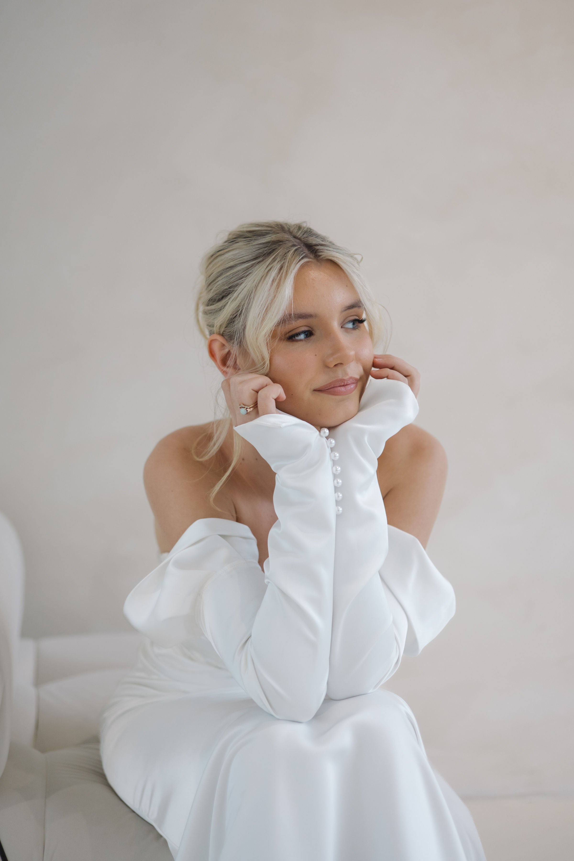 Bride wearing the Intentions crepe satin fit-and-flare wedding dress with sweetheart neckline and off-shoulder sleeves.