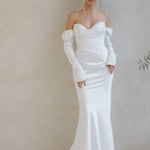 Intentions crepe satin fit-and-flare wedding dress with sweetheart neckline and off-shoulder sleeves.
