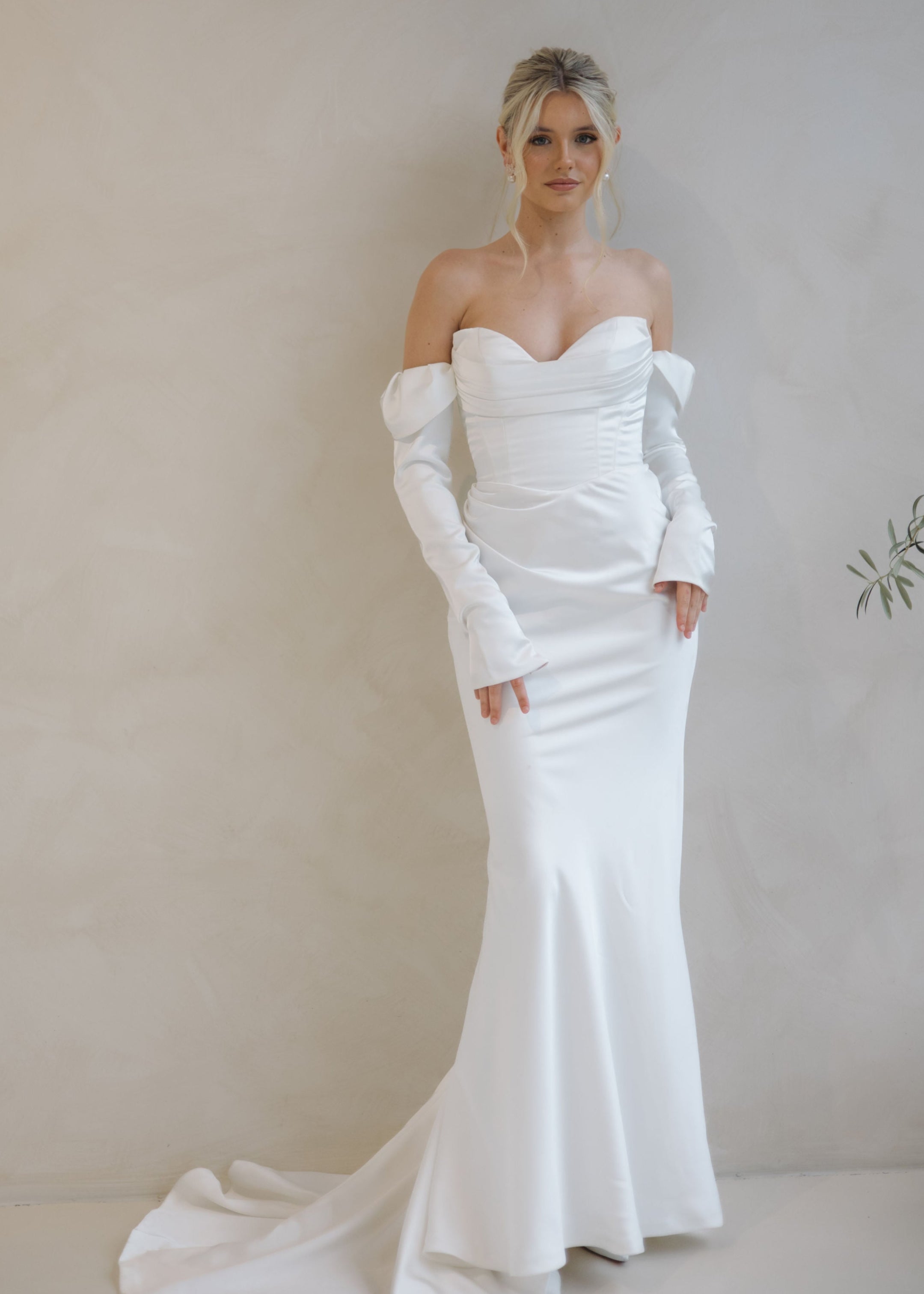 Intentions crepe satin fit-and-flare wedding dress with sweetheart neckline and off-shoulder sleeves.