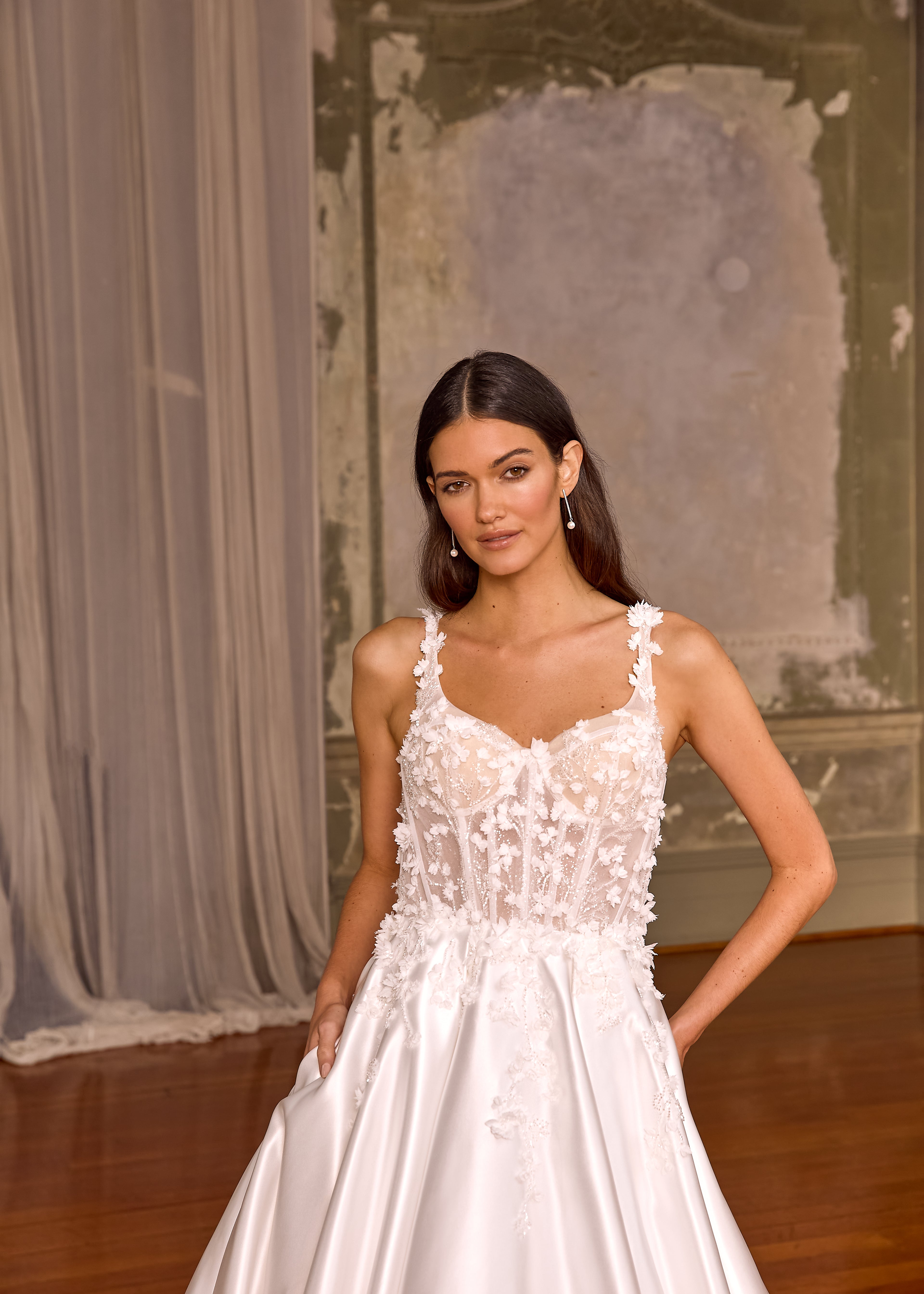 Close-up of satin ballgown wedding dress with lace illusion bodice, floral lace straps, and sweetheart neckline detail.
