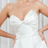 Close-up of Marigold Mikado wedding dress with strapless sweetheart bodice and draped detail.
