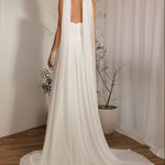 Ophelia romantic wedding dress back view with flowing chiffon cape and soft train