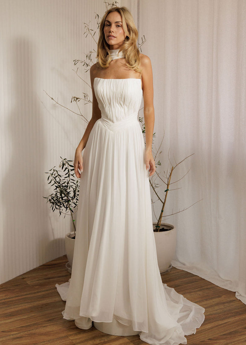 Elegant ivory bridal gown with pleated bodice and soft romantic style