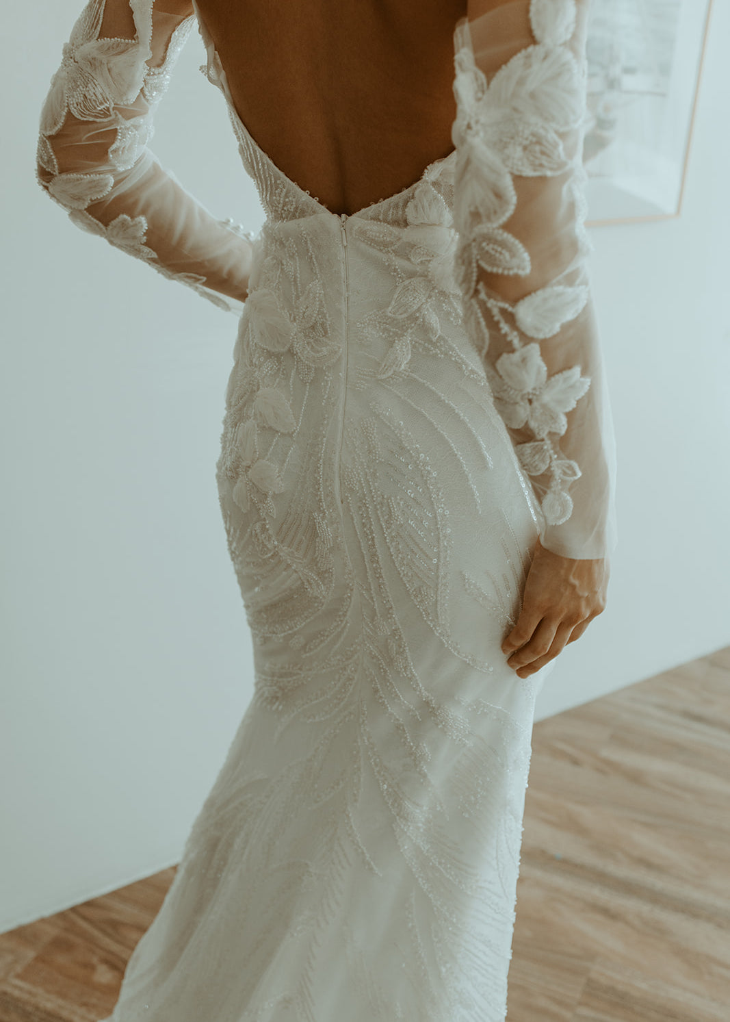Sequin Fit and Flare Wedding Dress with long sleeves and intricate detailing on a neutral background
