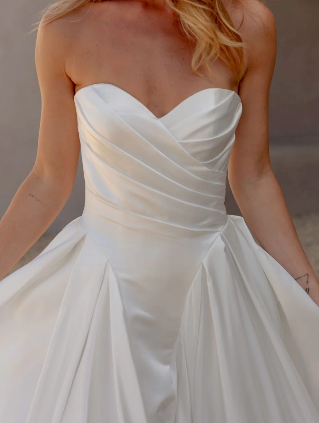 White strapless gown with a soft texture on a blurred background