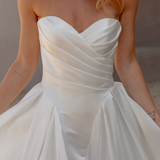 White strapless gown with a soft texture on a blurred background