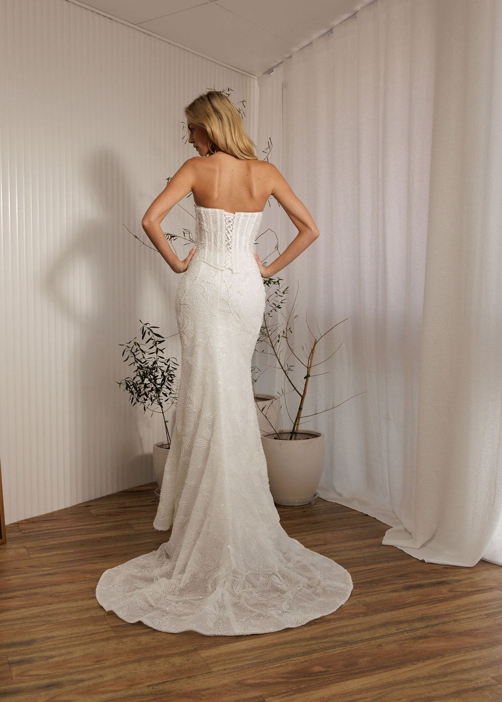 Back view of Prague beaded crepe fit-and-flare wedding dress with lace-up corset bodice and train