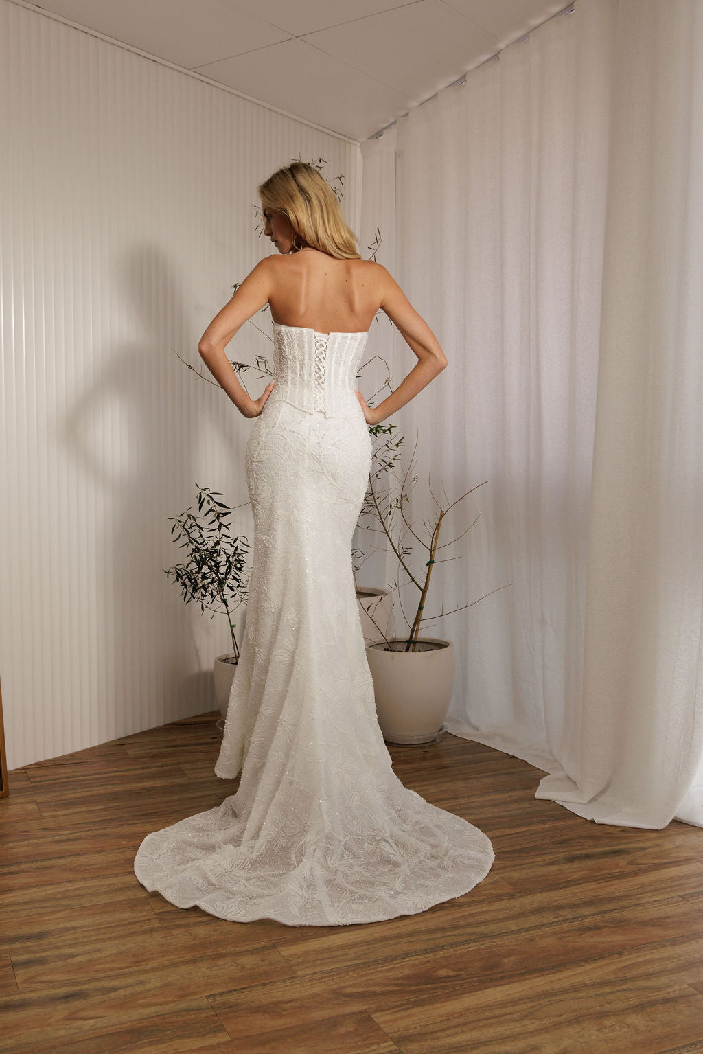 Back view of Prague beaded crepe fit-and-flare wedding dress with lace-up corset bodice and train