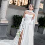 Queen wedding dress in Brisbane featuring off-shoulder neckline, long gloves and elegant front split