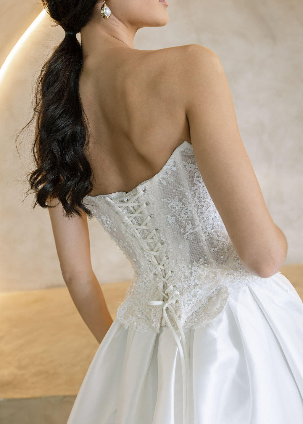 Viena satin A-line wedding dress back detail with lace corset bodice and lace-up closure.