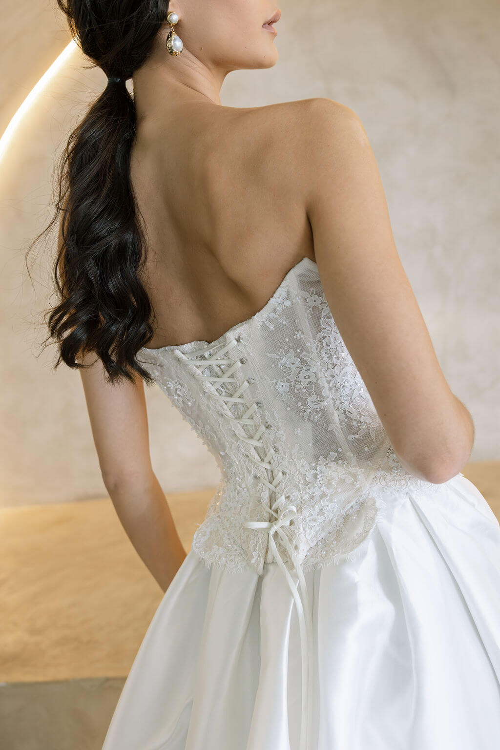 Viena satin A-line wedding dress back detail with lace corset bodice and lace-up closure.