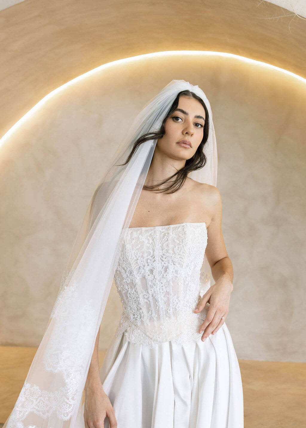 Viena satin A-line wedding dress with lace corset bodice and strapless neckline.