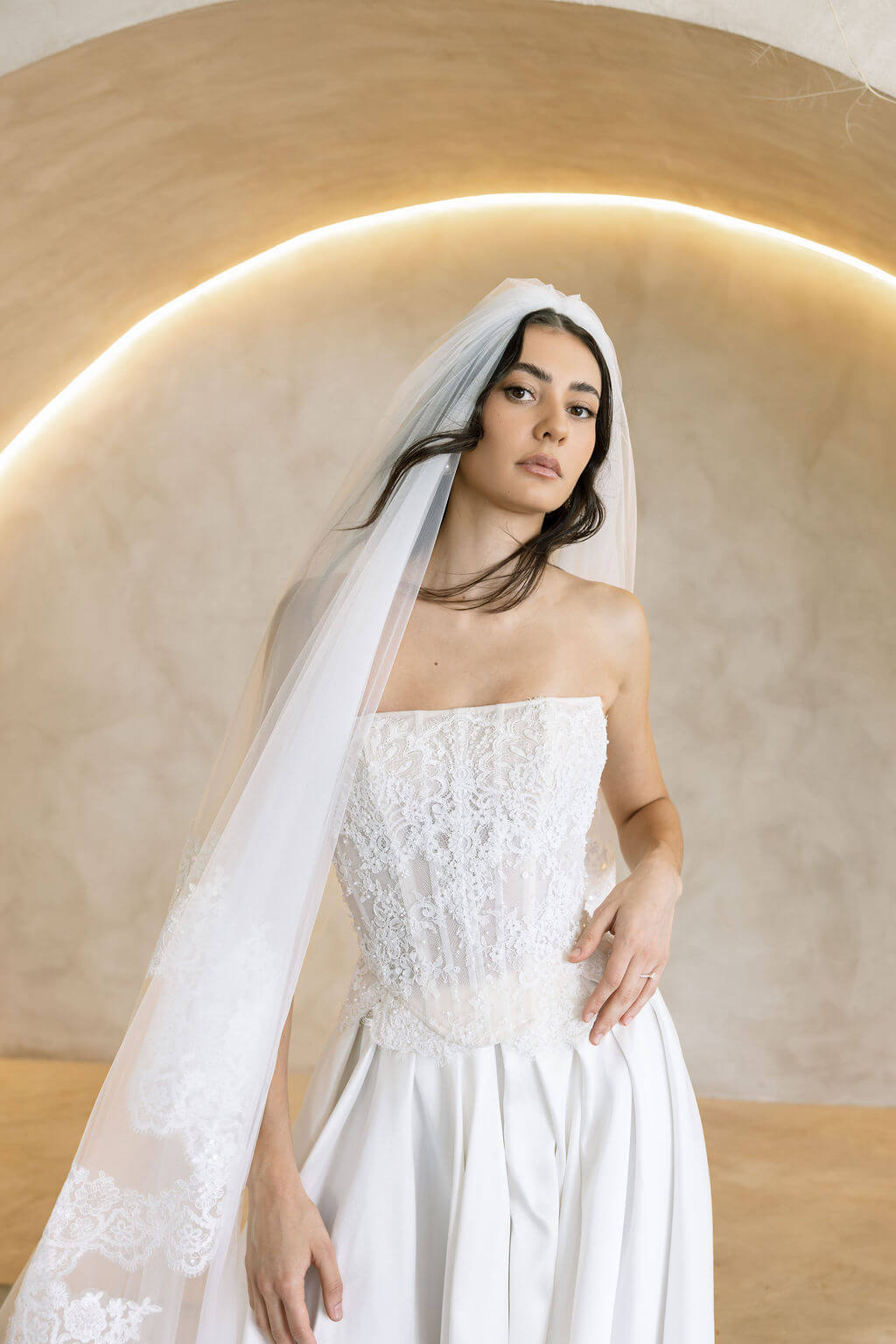 Viena satin A-line wedding dress with lace corset bodice and strapless neckline.