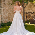 Back view of the Winona boho tulle A-line wedding dress with beaded bodice and flowing layered skirt.
