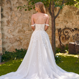 Back view of the Winona boho tulle A-line wedding dress with beaded bodice and flowing layered skirt.
