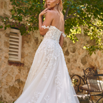 Back view of the Winona boho tulle A-line wedding dress with beaded bodice and flowing layered skirt.