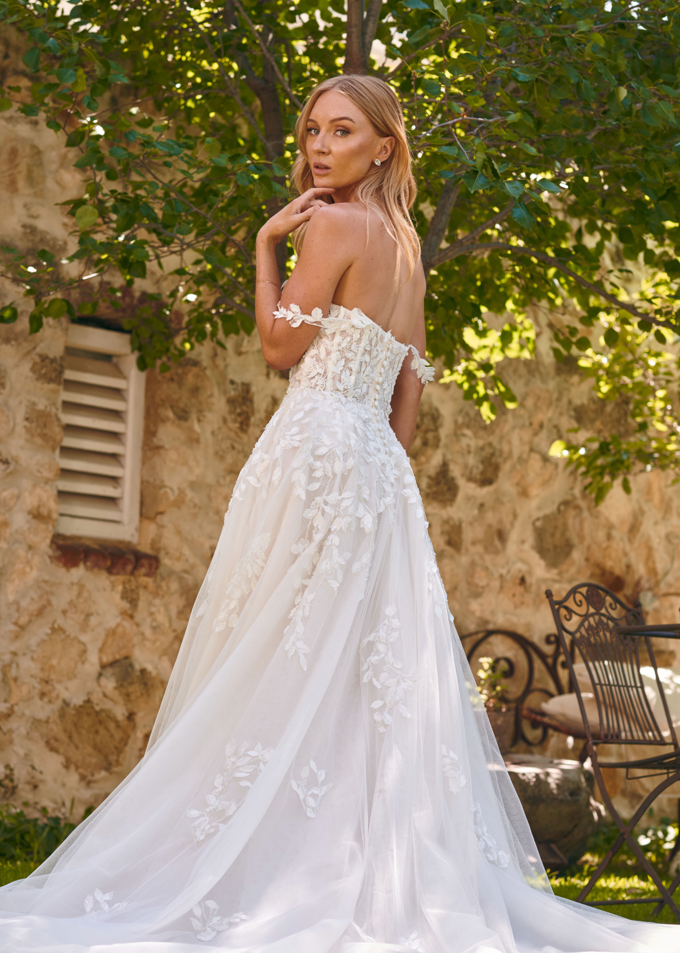 Back view of the Winona boho tulle A-line wedding dress with beaded bodice and flowing layered skirt.