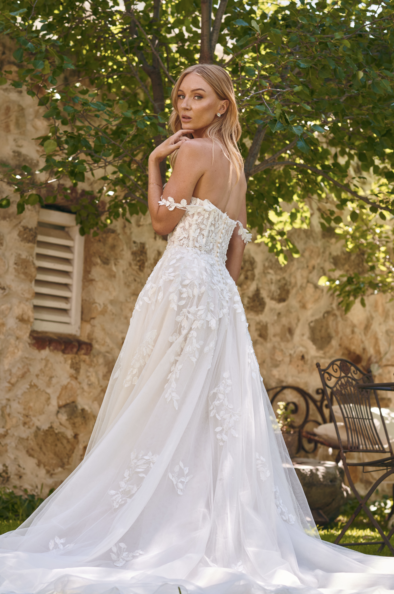 Back view of the Winona boho tulle A-line wedding dress with beaded bodice and flowing layered skirt.