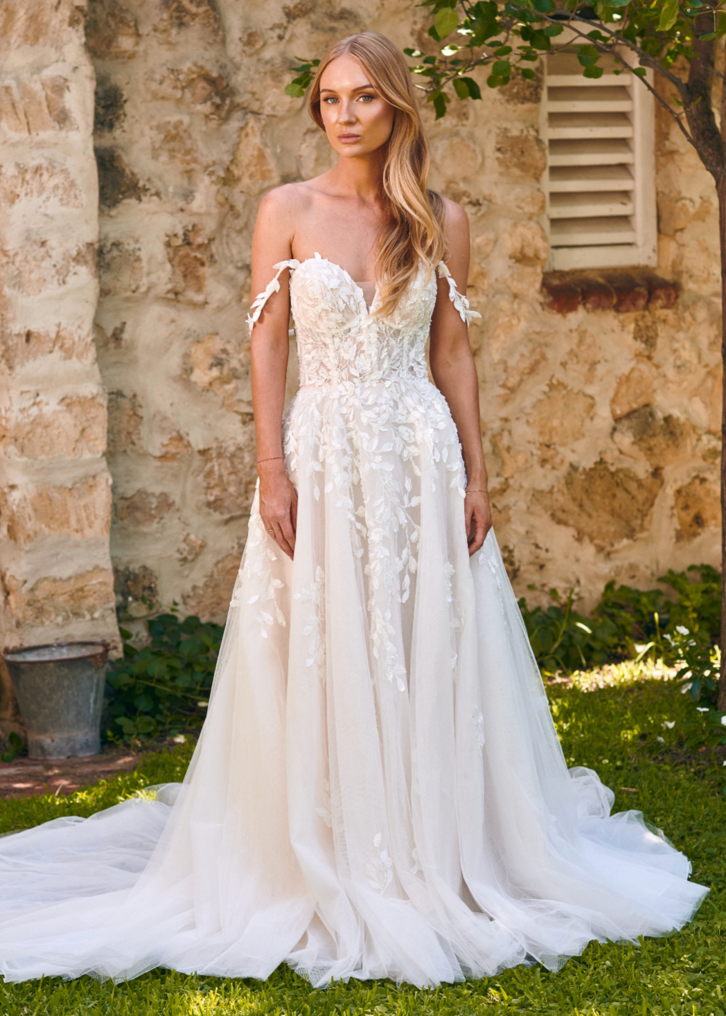 Winona boho tulle A-line wedding dress with beaded bodice and flowing layered skirt.