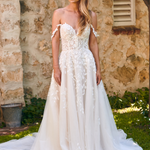 Winona boho tulle A-line wedding dress with beaded bodice and flowing layered skirt.