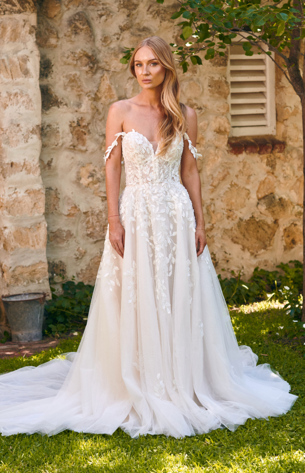 Winona boho tulle A-line wedding dress with beaded bodice and flowing layered skirt.