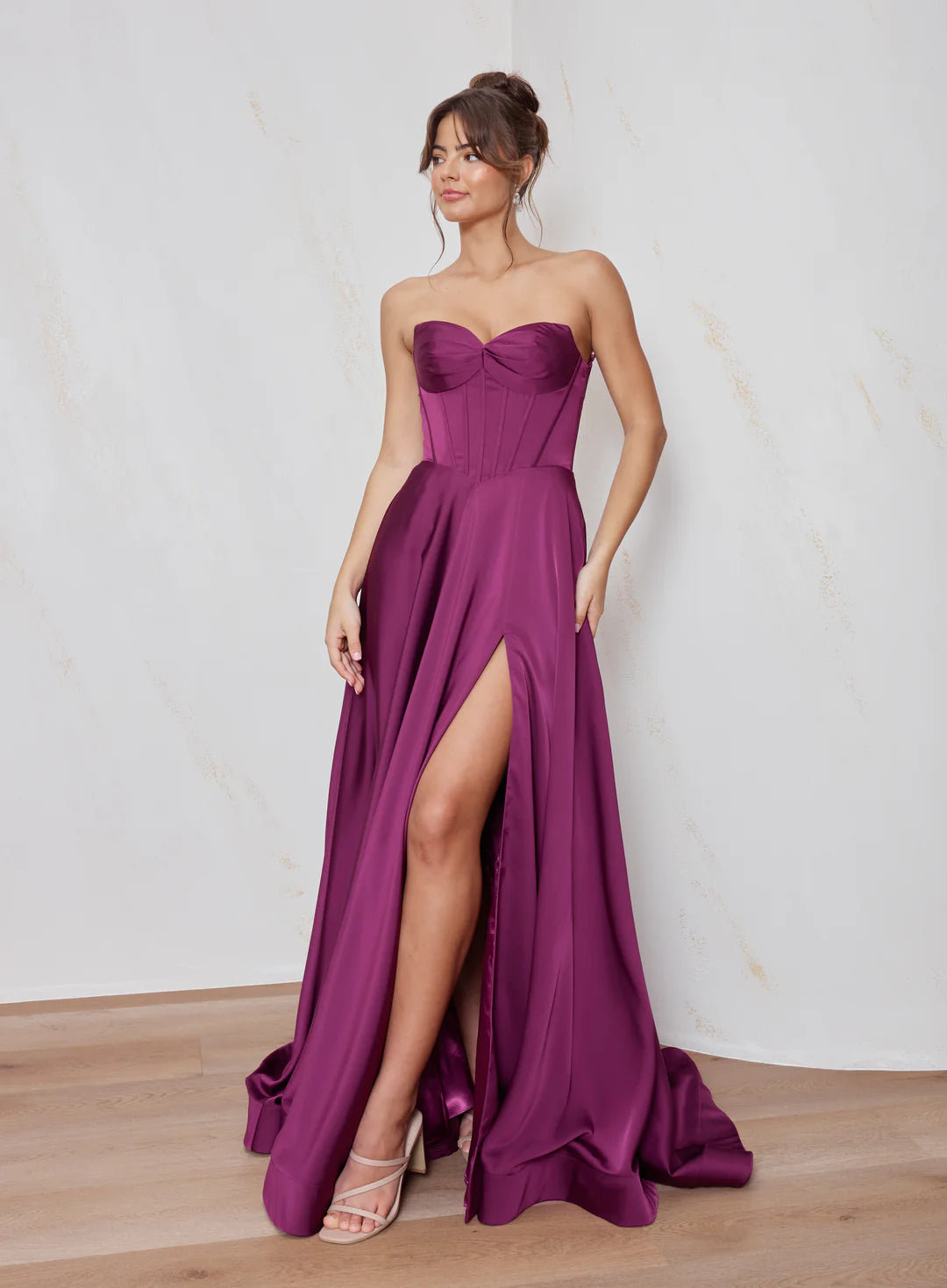 Celine satin A-line formal dress in Magenta with strapless corset bodice and structured flowing skirt.
